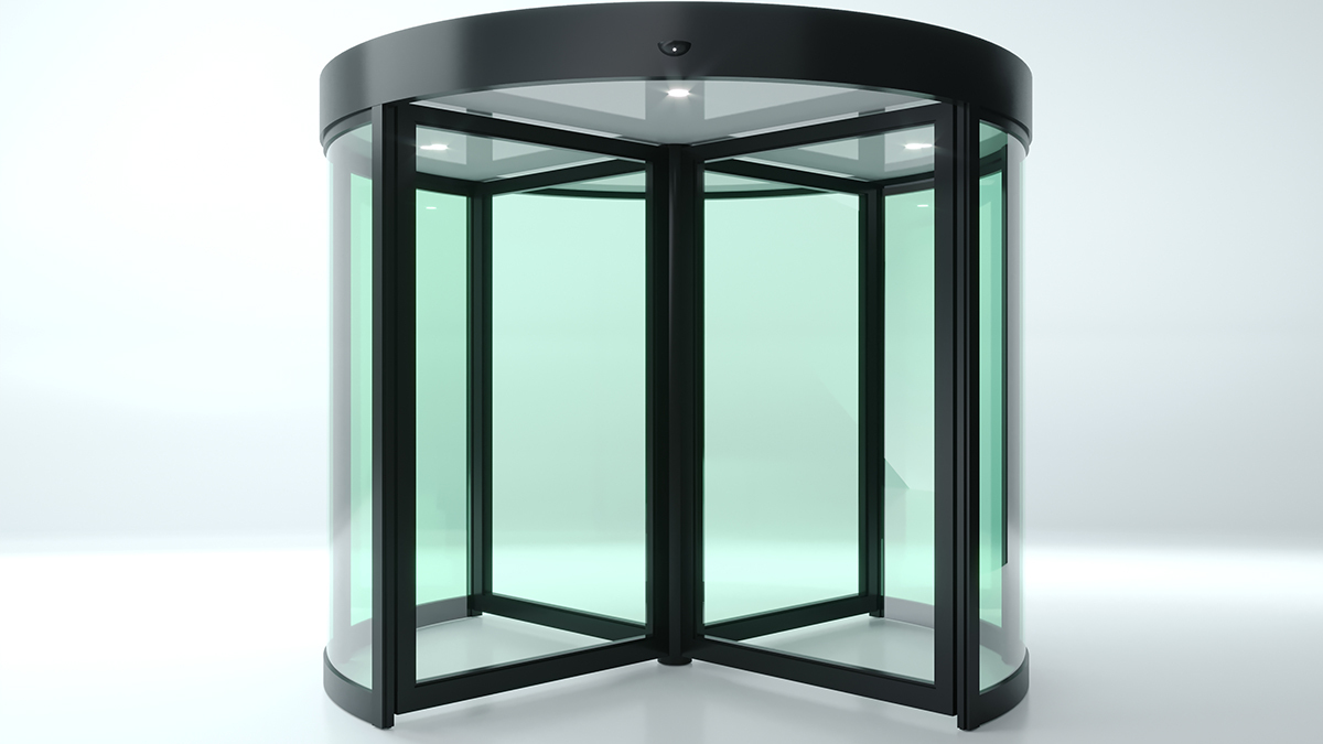 ประตูอัตโนมัติแบบบานหมุนทำจากกระจกใส กรอบสีดำ มีสี่บานหมุนอยู่ภายในโครงสร้างทรงกระบอก ตั้งอยู่บนพื้นสีขาว มีไฟส่องสว่างติดตั้งอยู่ด้านบน, Automatic revolving door made of clear glass with a black frame, featuring four rotating wings inside a cylindrical structure. It stands on a white floor, with built-in lighting at the top.